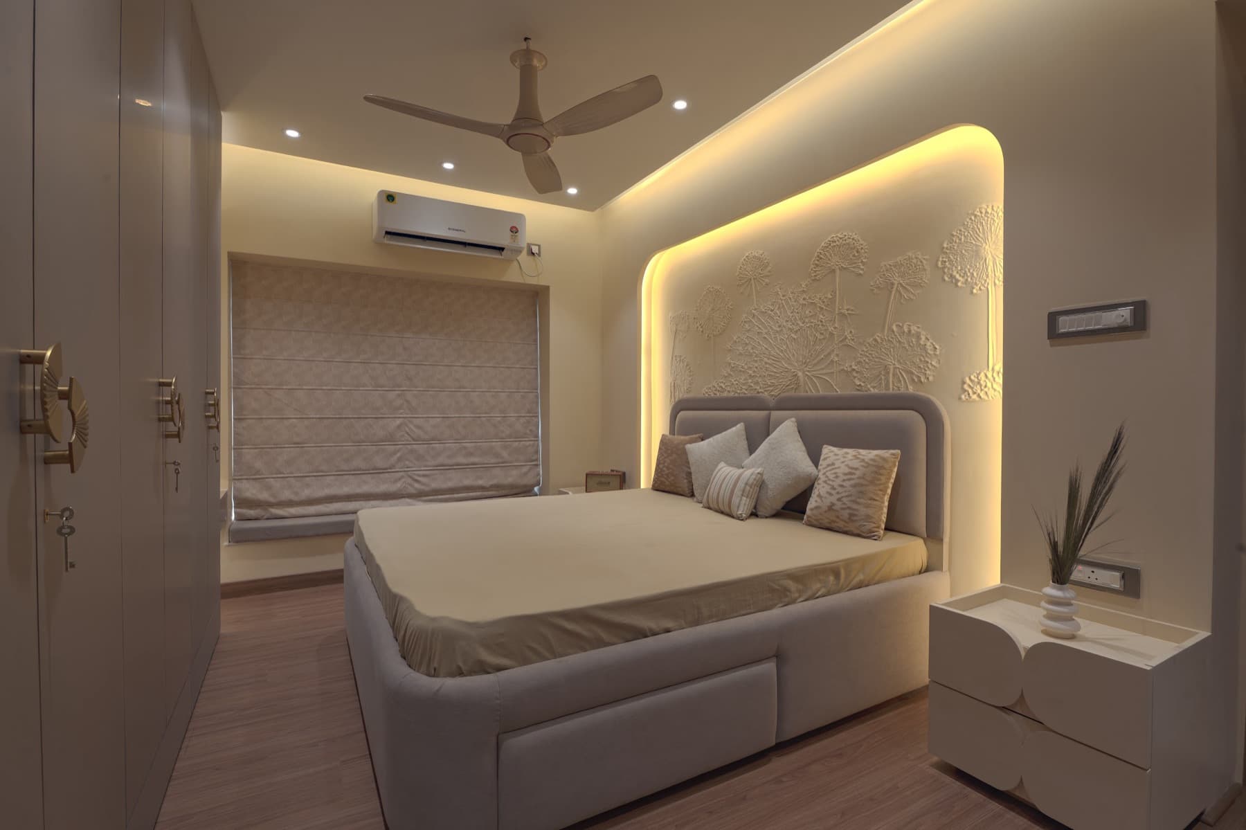 Cream bedroom with backlit floral relief headboard, upholstered bed, wardrobe and nightstand